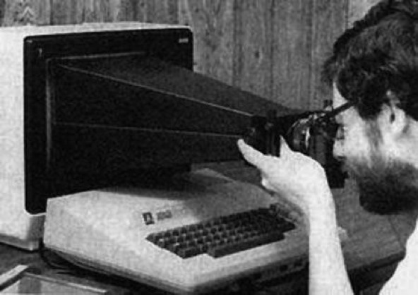 a man with a camera pointed at a screen